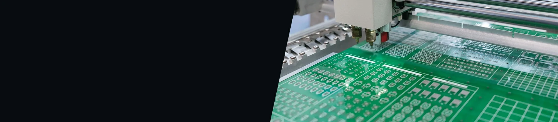 Technician assembling a metal electronics enclosure on a cleanroom production line with automated workstation equipment