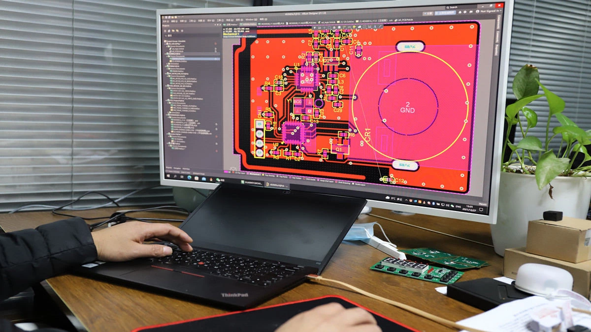 Engineer reviewing PCB files BOM and enclosure drawings